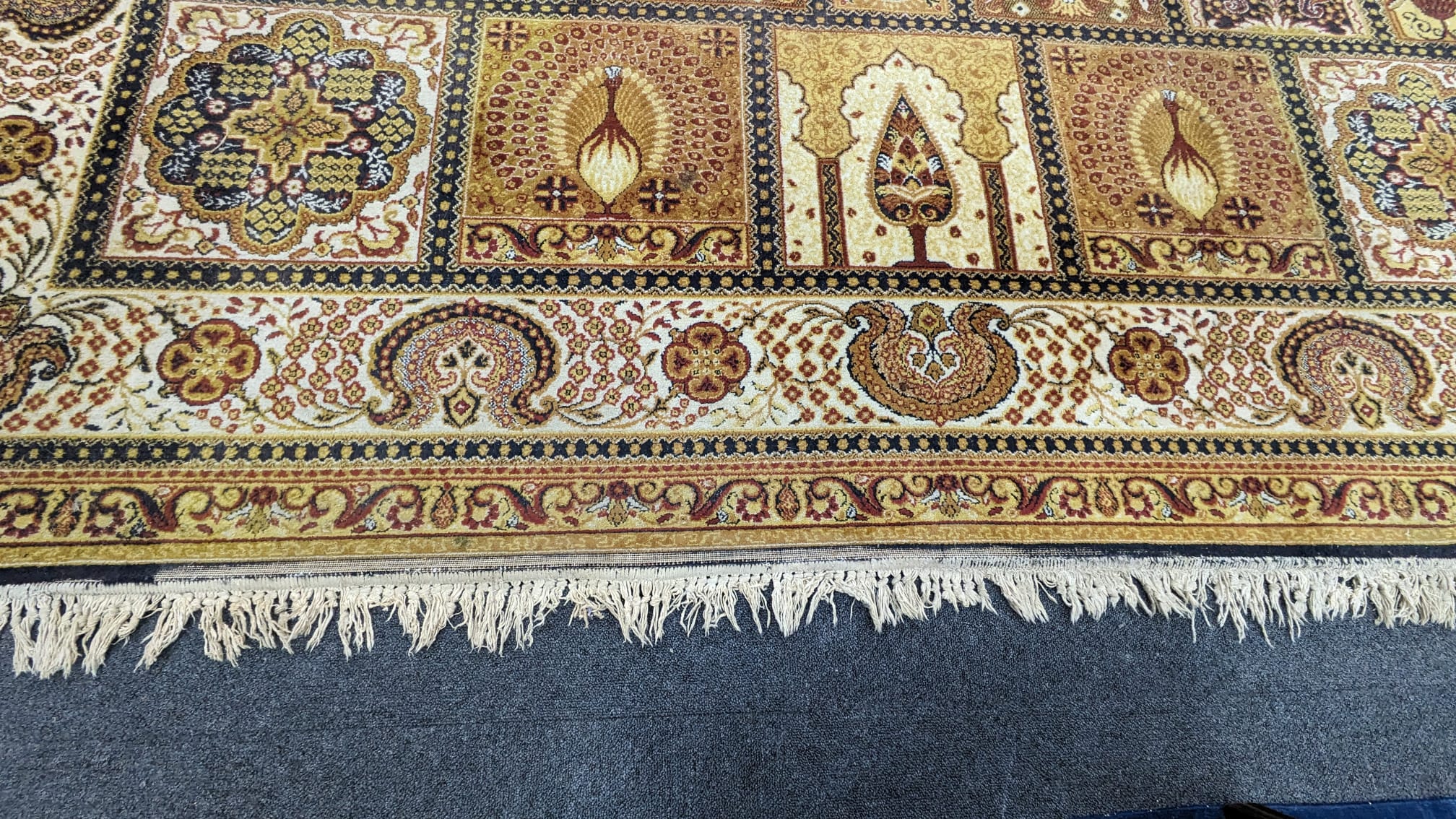 A Prado Orient 'Kashan Super' carpet with divided field of stylised flowers, peacocks and other motifs, multi-bordered, 372 x 275cm